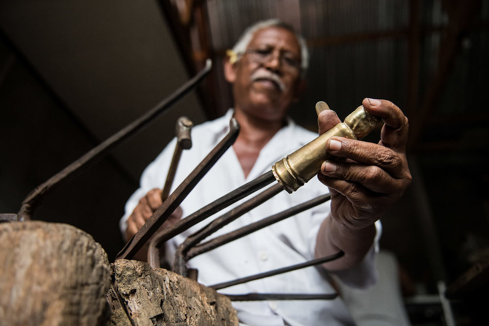  In the initial stage, using traditional tools for&nbsp; repoussé metalwork, he begins to shape a figurine handle. 
